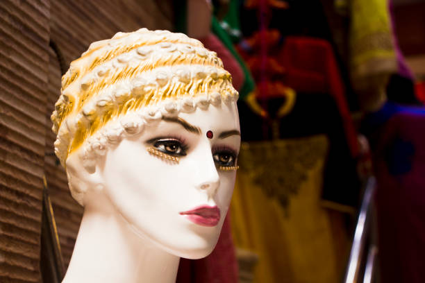 Colorful female mannequin head in Nepal with colorful style and a red bindi between eyebrows