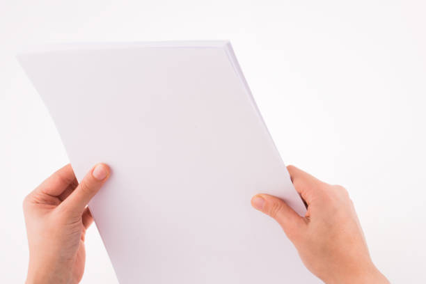 istock Hand holding a white blank sheet of paper 639070210