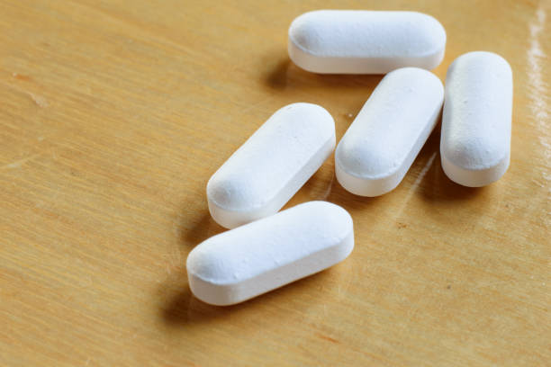 istock Closeup of some white pills 639070222