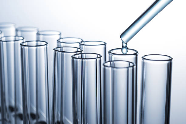 istock Liquid drop from pipette to laboratory glass test tube 639070340