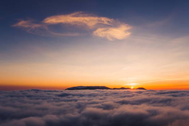 istock Beautiful sunset on the hill above clouds 639070692