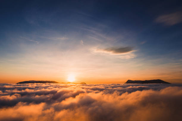 istock Beautiful sunset on the hill above clouds 639070736