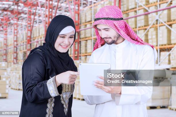 Businesswoman Discuss With Her Partner In Warehouse Stock Photo - Download Image Now