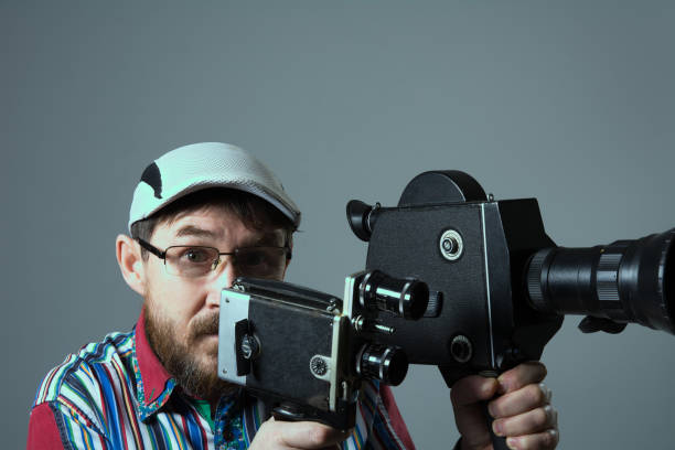 istock Bearded man two old retro film camera 639075606