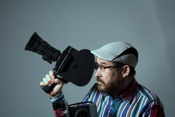 istock Bearded man two old retro film camera 639075686