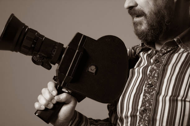 istock Bearded Man Movie Camera thoughtfully looks 639076002