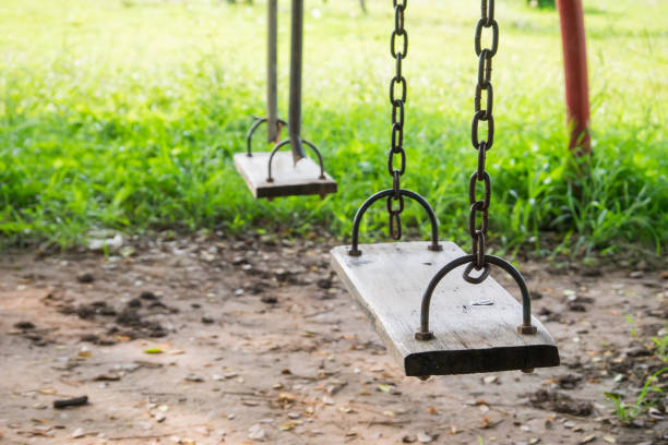 istock Old wooden swing in playground 639082524
