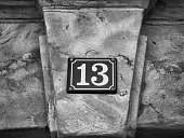 Street sign - House number 13 on sandstone wall