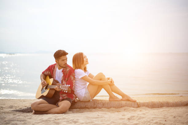 istock Cute hispanic couple playing guitar serenading 639085222