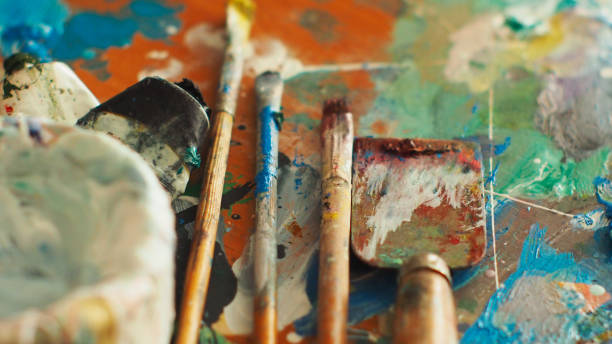 istock Brush and bright oil-paint palette for background 639085726