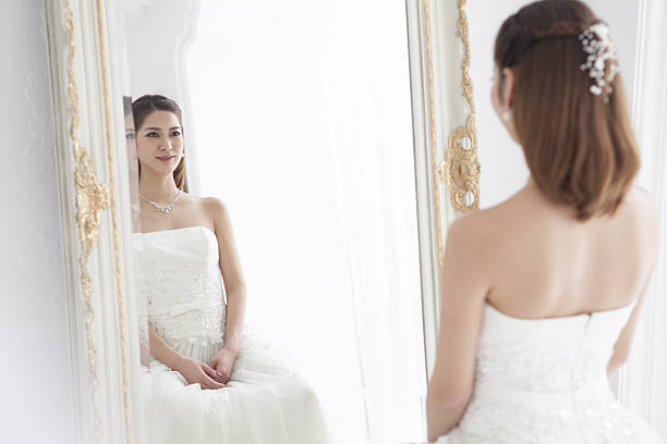 istock The bride stares at herself in the mirror. 639085794