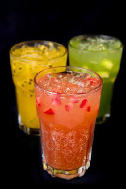 Mix fruit juice in black background,Strawberry front