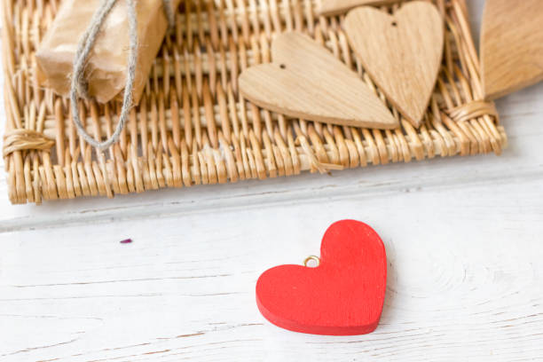istock One red and few brown wooden hearts 639087166