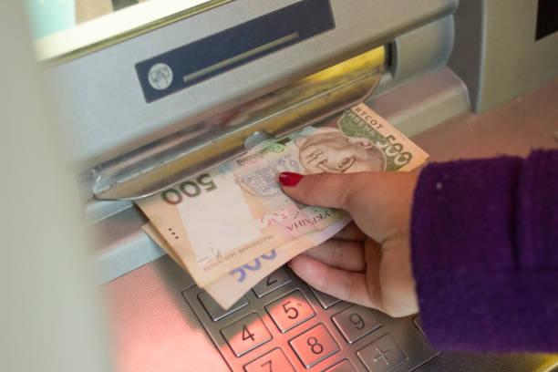 istock ATM and holding a credit card 639087508