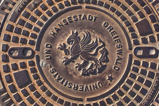 Manhole cover with coat of arms of the Hanseatic city of Greifswald