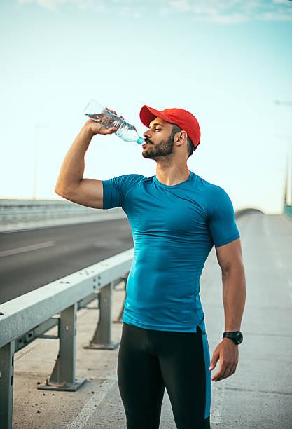 istock Muscular athlete with strong abs drinking water 639088538