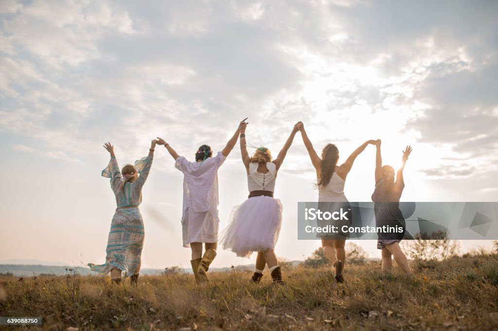 Mystic Hippie girls Group of happy female friends running on meadow. Spirituality Stock Photo