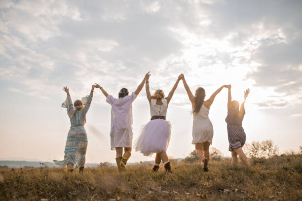 Mystic Hippie girls Group of happy female friends running on meadow. ceremonial dancing stock pictures, royalty-free photos & images