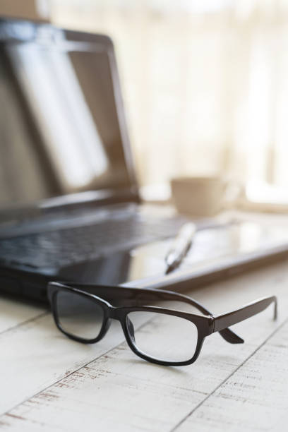 istock Eyeglasses on office desk with laptop at workplace 639090176