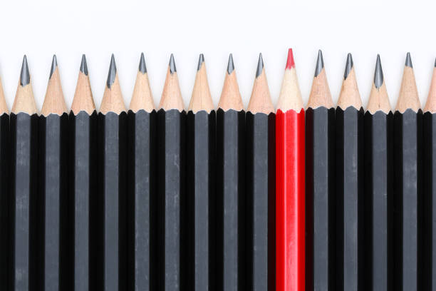 istock Red pencil standing out from crowd of plenty identical 639090480