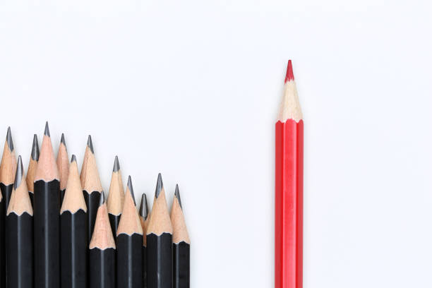 istock Red pencil standing out from crowd of plenty identical 639090656