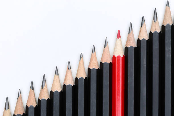 istock Red pencil standing out from crowd of plenty identical 639091056