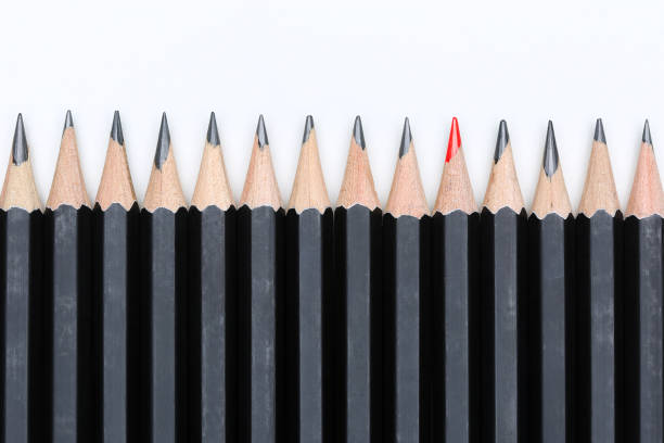 istock Red pencil standing out from crowd of plenty identical 639091242