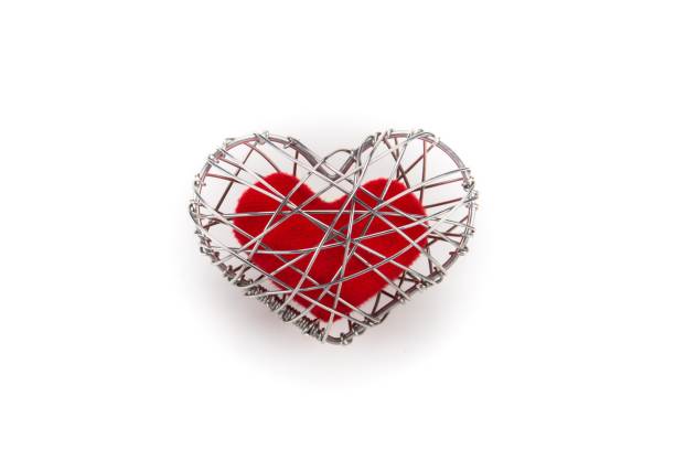 istock red fabric heart in knitted wire cage on white background 639092348