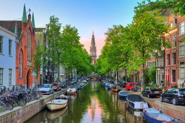 Beautiful Groenburgwal canal in Amsterdam with the Soutern church (Zuiderkerk) at sunset in summer