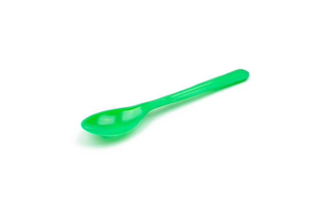 istock Green plastic spoon isolated on white background 639093396