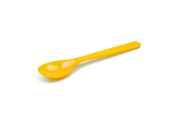 istock Orange plastic spoon isolated on white background 639093432