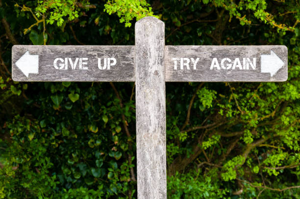 istock GIVE UP versus TRY AGAIN directional signs 639094646