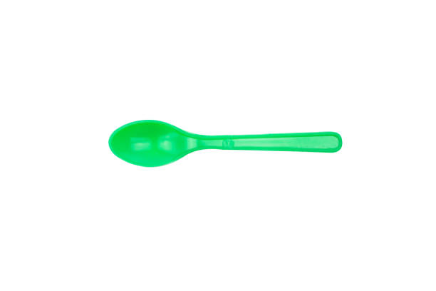 istock Green plastic spoon isolated on white background 639095528