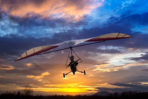 istock Motorized hang glider flying in the sunset 639099070