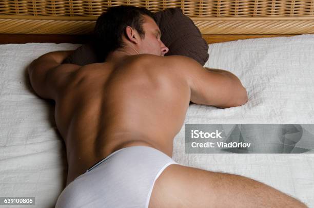 Sexy Guy Sleeping On The Bed Stock Photo - Download Image Now - Men, Buttocks, Sensuality