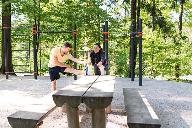 istock Young couple stretching before running 639101476