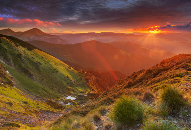 istock Amazing colorful sunrise in mountains with colored sunrays 639103668