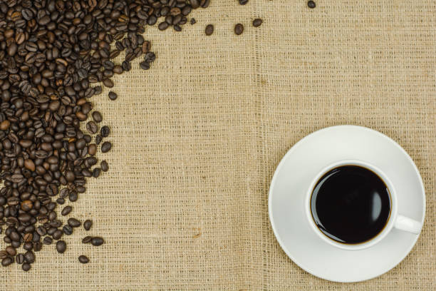istock White cup with coffee drink on sackcloth background 639104172