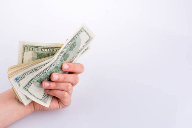 istock Human hand holding American dollar banknotes on white background 639104764