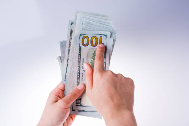 istock Human hand holding American dollar banknotes on white background 639105394