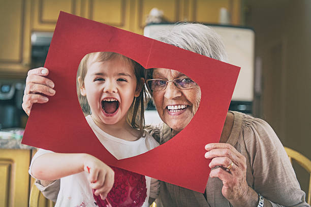 bambina che fa bricolage con la nonna - grandmother senior adult family domestic kitchen foto e immagini stock