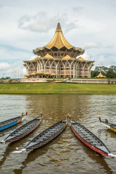 Kuching, Malaysia, Parliament building and longboats under the water festival The new Parliament, Kuching, Sarawak, under the water festival in November 2016. Longboats lay on river in front of the building. Dramatic clouds behind. kuching waterfront stock pictures, royalty-free photos & images