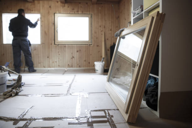 Worker installing new wooden windows