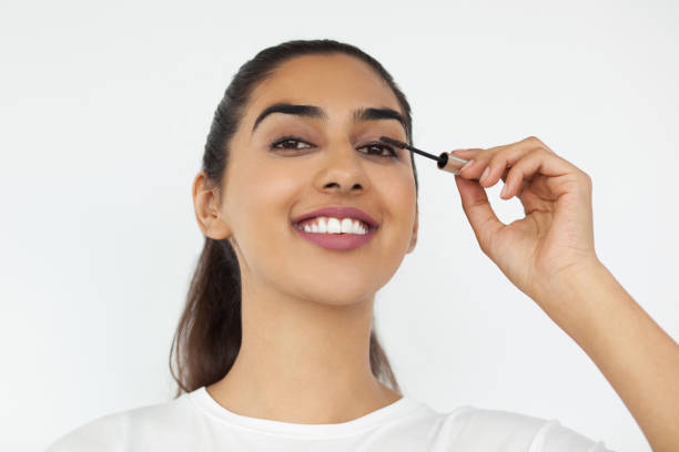 istock Smiling Indian Woman Applying Mascara 639106518