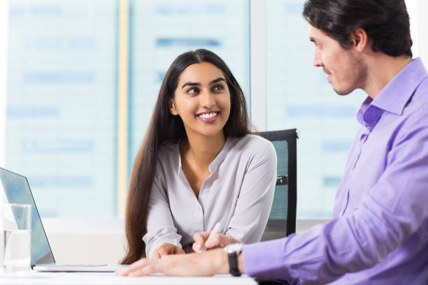 istock Smiling Male and Female Coworkers Talking at Work 639106910