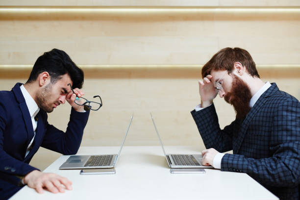 due uomini d'affari stanchi che lavorano in ufficio - human eye tired rubbing businessman foto e immagini stock