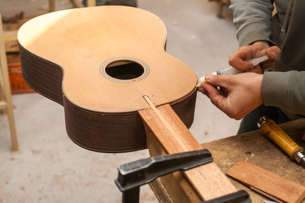 istock The worker glues guitar 639108840