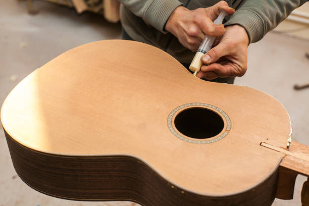 istock The worker glues guitar 639109066