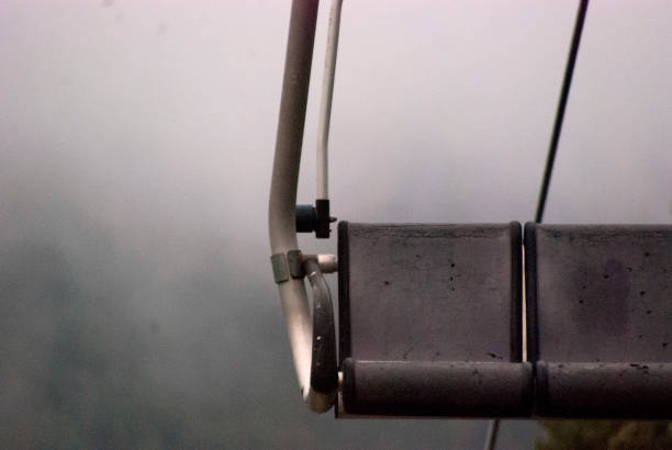 Chairlift on the mountain on a cloudy and rainy day.