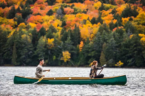 Photo of Couple enjoying a ride on a typical canoe in Canada